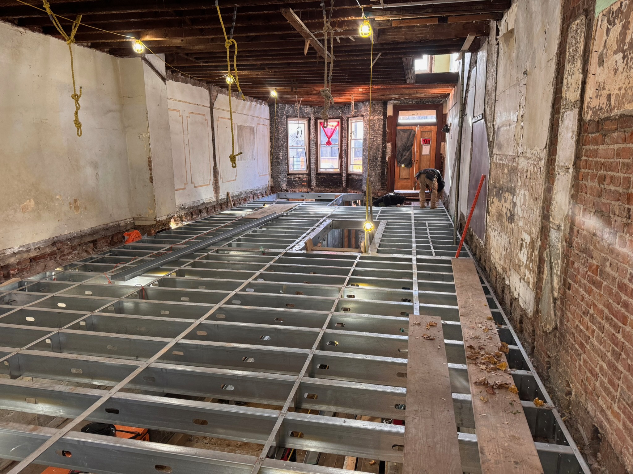 Steel floor joists installed inside an existing brick building